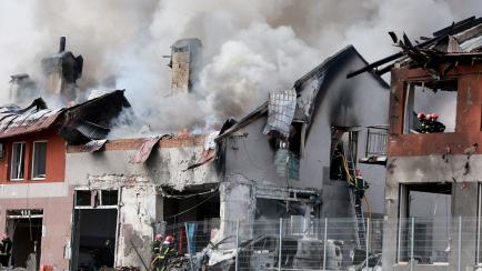 LVIV, UKRAINE - APRIL 18: Firefighters battle a blaze after a civilian building was hit by a Russian missile on April 18, 2022 in Lviv, Ukraine. At least six people were killed and eight wounded in missile strikes in different areas of the city,...