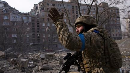 FILE - A Ukrainian serviceman guards his position in Mariupol, Ukraine, Saturday, March 12, 2022. Russia began evacuating its embassy in Kyiv, and Ukraine urged its citizens to leave Russia. Unbroken by a Russian blockade and relentless bombardm...