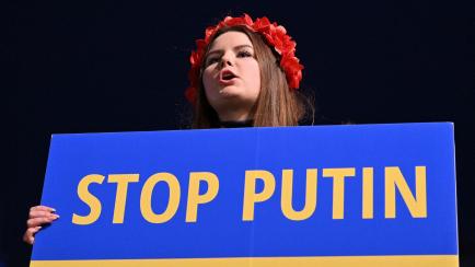 A person holds a placard reading 'Stop Putin' during a rally in support of Ukraine in Trafalgar Square in London on March 9, 2022, following the invasion of the country by Russia. (Photo by JUSTIN TALLIS / AFP) (Photo by JUSTIN TALLIS/AFP via Ge...