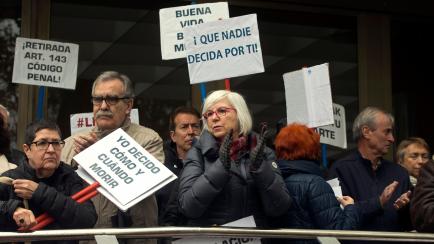 People applaud during a protest outside one of the main courts in Madrid, Spain, Friday, April 5, 2019. A Madrid court has released Angel Hernandez, a 70-year-old man who admitted to helping his 61-year-old wife end her life and who was diagnose...