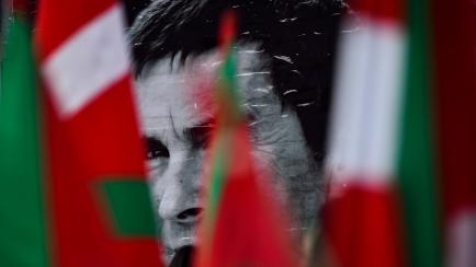 A protait of Arnaldo Otegi, leader of the former Basque independence Batasuna party, is seen between Basque flags in small town of Elgoibar, northern Spain, Tuesday, March 1,2016. A prominent Basque separatist has been released from a Spanish pr...