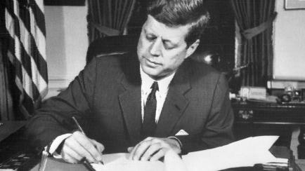 US President John Fitzgerald Kennedy signs the order of naval blockade of Cuba, on October 24, 1962 in White House, Washington DC, during the Cuban missiles crisis. On October 22, 1962, President Kennedy informed the American people of the prese...