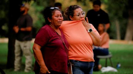 People react outside the Ssgt Willie de Leon Civic Center, where students had been transported from Robb Elementary School after a shooting, in Uvalde, Texas, U.S. May 24, 2022.  REUTERS/Marco Bello  REFILE - QUALITY REPEAT