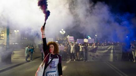 a young woman with a purple flare during the demonstration in Santander (Spain), on the occasion of the celebration of the festivity of March 8 "international women's day" that toured the main streets of the city. , in Santander, Spain...