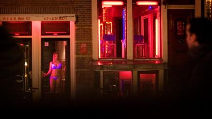 Sex workers are seen in the Red Light district of Amsterdam, Netherlands, Sunday, Dec. 7, 2008. Amsterdam detailed plans on Monday Dec. 8, 2008, for a major cleanup of its ancient city center, including shuttering up to half of its famed brothel...