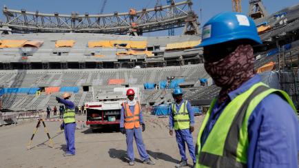 Workers work at Lusail Stadium, one of the 2022 World Cup stadiums, in Lusail, Qatar, Friday, Dec. 20, 2019. Construction is underway to complete Lusail's 80,000-seat venue for the opening game and final in a city that didn't exist when Qatar wo...