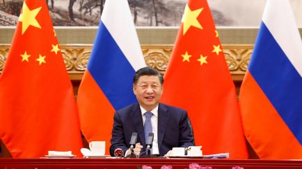 In this photo released by China's Xinhua News Agency, Chinese President Xi Jinping speaks during a virtual meeting with Russian President Vladimir Putin in Beijing, Wednesday, Dec. 15, 2021. Chinese President Xi Jinping supported Russian Preside...