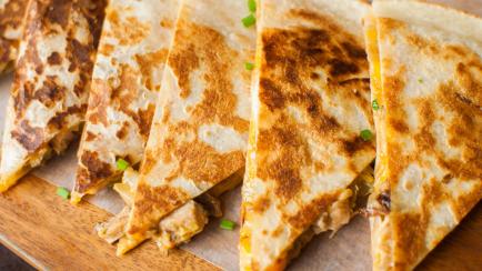 A close-up of cheese quesadilla gourmet on a wooden table