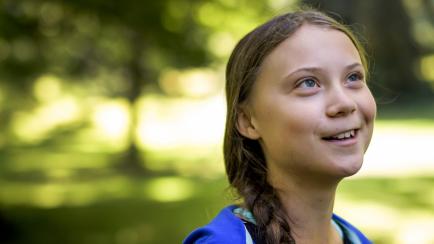 Swedish youth climate activist Greta Thunberg smiles during a meeting with Intergovernmental Panel on Climate Change (IPCC) representatives after the launch of a special IPCC report on climate change and land on August 8, 2019 in Geneva. - Human...