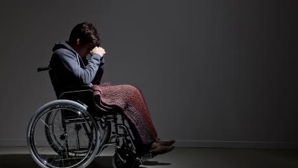 Frustrated Caucasian man in wheelchair