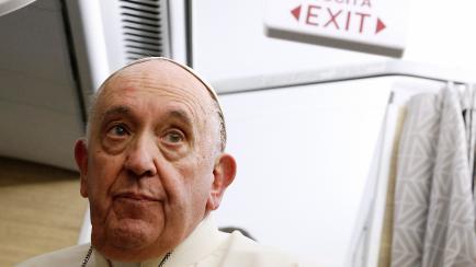Pope Francis reacts during a news conference aboard the papal plane on his flight back after visiting Canada, July 29, 2022. - Pope Francis ended his six-day trip to Canada on July 29, 2022 as he began with a historic apology for the harm done t...