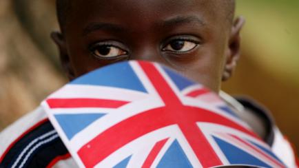 A young boy waits for Prince Charles and his wife Camilla at St. Joseph's School in Naggalama on the outskirts of Kampala, Uganda on Nov. 24, 2007. Prince Charles is in Uganda for the first time on the sidelines of the bi-annual Commonwealth Hea...