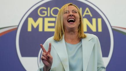 Far-Right party Brothers of Italy's leader Giorgia Meloni flashes the victory sign at her party's electoral headquarters in Rome, early Monday, Sept. 26, 2022. Italian voters rewarded Giorgia Meloni's euroskeptic party with neo-fascist roots, pr...