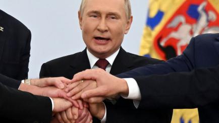 Russian President Vladimir Putin joins hands with Moscow-appointed head of Kherson Region Vladimir Saldo, Moscow-appointed head of Zaporizhzhia region Yevgeny Balitsky, Denis Pushilin, leader of self-proclaimed Donetsk People's Republic and Leon...