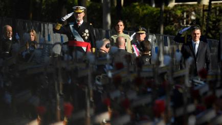 King Felipe VI of Spain (L), Queen Letizia of Spain (2L) and Spain's Prime Minister Pedro Sanchez (R) attend the Spanish National Day military parade in Madrid on October 12, 2022. (Photo by OSCAR DEL POZO CANAS / AFP) (Photo by OSCAR DEL POZO C...