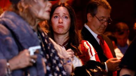 A supporter of Republican gubernatorial candidate Lee Zeldin reacts as media outlets begin to call the race for Democratic incumbent Kathy Hochul at Zeldin's election night party, Tuesday, Nov. 8, 2022, in New York. (AP Photo/Jason DeCrow)