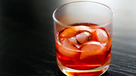 Negroni, bright, bitter sweet Italian cocktail made with sweet red vermouth, gin, campari, ice and an orange peel.