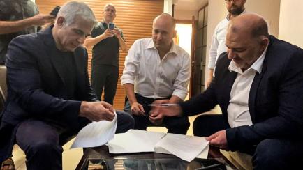 United Arab List party leader Mansour Abbas, Yamina party leader Naftali Bennett and Yesh Atid party leader Yair Lapid, sit together in Ramat Gan, near Tel Aviv, Israel June 2, 2021.  United Arab List Raam/Handout via REUTERS
