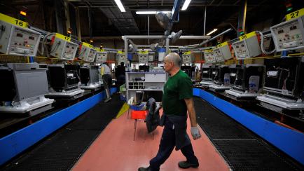 In this photo taken Oct. 18, 2012, a worker walks in the production line area of the Fagor factory, part of the Mondragon cooperative, in Arrasate, Spain. Amid the recession that profoundly affects Europe and Spain, the Basque region has managed...