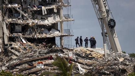 SURFSIDE, FLORIDA - JUNE 27: Search and Rescue teams look for possible survivors in the partially collapsed 12-story Champlain Towers South condo building on June 27, 2021 in Surfside, Florida. Over one hundred people are being reported as missi...