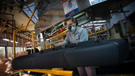 TO GO WITH AFP STORY BY GABRIEL RUBIO
A Copo Galicia employee works on a car seat production line in Mos, northwestern Spain on December 9, 2015. Amid the Spanish economic crisis, some sectors, such as automobiles, managed to limit the damage ev...
