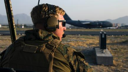 In this image provided by the U.S. Marine Corps, a Marine assigned to the 24th Marine Expeditionary Unit monitors the air traffic control center at Hamid Karzai International Airport in Kabul, Afghanistan, Sunday, Aug. 22, 2021. (Cpl. Davis Harr...