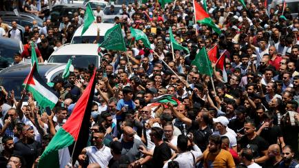 People attend the funeral of Palestinian critic Nizar Banat, who died after being arrested by Palestinians Authority's security forces, in Hebron in the Israeli-occupied West Bank, June 25, 2021. REUTERS/Mussa Qawasma