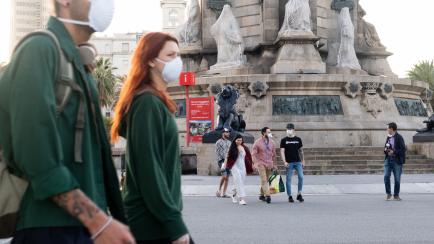 BARCELONA, SPAIN - 2020/05/02: People are seen walking along the street while wearing face masks as a precaution during the first day out amid Coronavirus restrictions.
After 49 days locked in their houses today for the first-time millions of Sp...