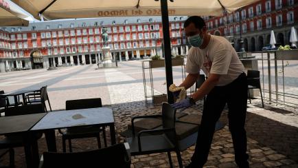 MADRID, SPAIN - MAY 24: Employees prepare their workplace for re-opening after authorities allow cafes and restaurants to re-open beginning from May 25 as part of the coronavirus normalization process, at the Plaza Mayor in Madrid, Spain on May ...