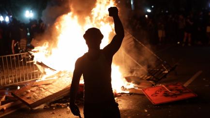 WASHINGTON, DC - MAY 31:  Demonstrators set a fire during a protest near the White House on May 31, 2020 in Washington, DC. Minneapolis police officer Derek Chauvin was arrested for Floyd's death and is accused of kneeling on Floyd's neck as he ...