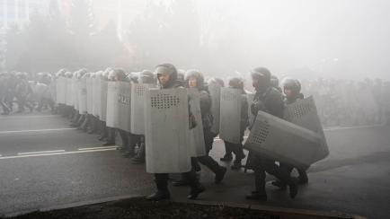 Riot police walk to block demonstrators during a protest in Almaty, Kazakhstan, Wednesday, Jan. 5, 2022. Demonstrators denouncing the doubling of prices for liquefied gas have clashed with police in Kazakhstan's largest city and held protests in...