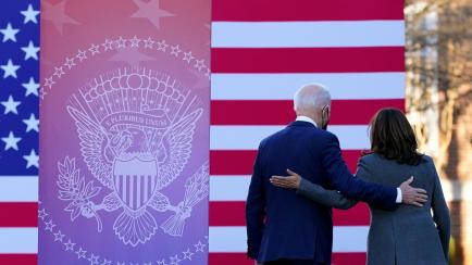 President Joe Biden and Vice President Kamala Harris walk off stage after speaking in support of changing the Senate filibuster rules that have stalled voting rights legislation, at Atlanta University Center Consortium, on the grounds of Morehou...