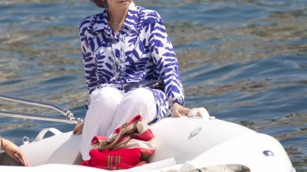 Spain's Queen Sofia sits on a boat as she looks at her grandchildren on the first day at their sailing school in Palma de Mallorca on July 28, 2014. The Royal Family spend their traditional summer holidays at the Marivent Palace.   AFP PHOTO/ JA...