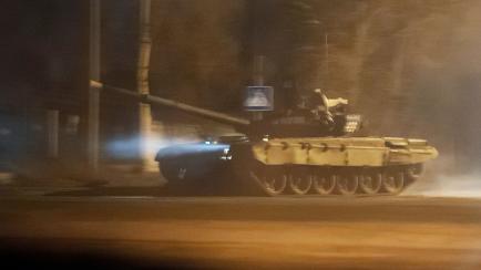 A tank drives along a street after Russian President Vladimir Putin ordered the deployment of Russian troops to two breakaway regions in eastern Ukraine following the recognition of their independence, in the separatist-controlled city of Donets...