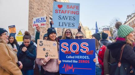 LONDON, UNITED KINGDOM - 2022/12/20: Nurses hold 'Save our staff' placards during the demonstration at the picket line outside Great Ormond Street Hospital. Nurses and Royal College of Nursing members have walked out for the second day of the fi...