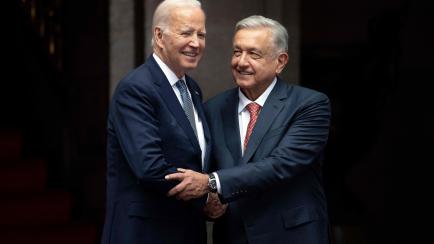 Mexican President Andres Manuel Lopez Obrador greets US President Joe Biden during an official welcome ceremony at the National Palace in Mexico City on January 9, 2023. (Photo by Jim WATSON / AFP) (Photo by JIM WATSON/AFP via Getty Images)
