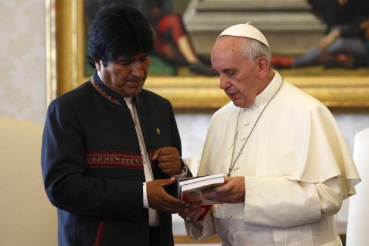 Bolivian President Evo Morales, left, exchanges gifts with Pope Francis, at the Vatican, Friday, Sept. 5, 2013. (AP Photo/Riccardo De Luca, Pool)