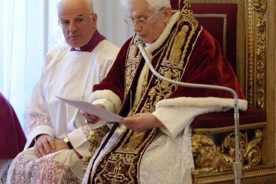 RECROP OF VAT114 - In this photo provided by the Vatican newspaper L'Osservatore Romano, Mons. Franco Comaldo, a pope aide, left, looks at Pope Benedict XVI as he reads a document in Latin where he announces his resignation, during a meeting of ...