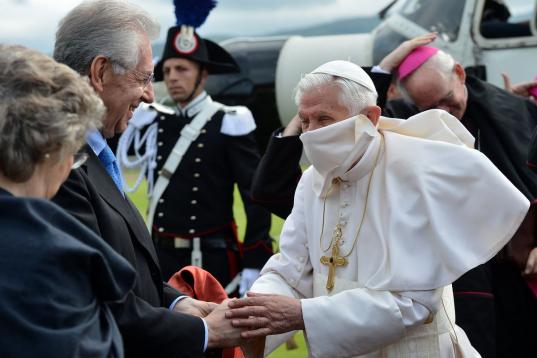 Pope Benedict XVI (R) is greeted by Italian Prime Minister Mario Monti and his wife Elsa (L) as he disembarks from a helicopter in Arezzo stadium on the start of a one day pastoral visit on May 13, 2012. The Pope will lead a Holy Mass and will a...