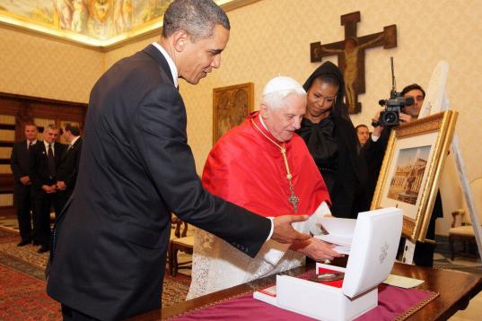VATICAN CITY, VATICAN - JULY 10:  US President Barack Obama (L) and First Lady Michelle Obama exchange gifts with Pope Benedict XVI in his library at the Vatican on July 10, 2009 in Vatican City, Vatican. Obama was meeting with The Pope for the ...