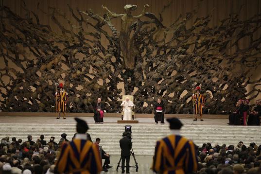 Pope Benedict XVI attends his weekly general audience at the Vatican, Wednesday, Dec. 22, 2010. In background is a bronze sculpture, the Resurrection, by artist Pericle Fazzini. (AP Photo/Alessandra Tarantino)