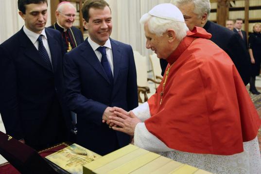 Pope Benedict XVI (R) exchanges presents with Russian President Dmitry Medvedev (C) during an audience at The Vatican on December 3, 2009. Russia and the Vatican have established full diplomatic relations ending longstanding tensions, the Kremli...