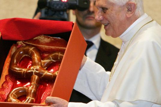 Vatican City, VATICAN CITY STATE:  Pope Benedict XVI holds a gift during during a special audience for an Austrian delegation at the Vatican, 17 December 2005. The Christmas tree, a donation from Austria, will later be lit on St-Peter's square. ...