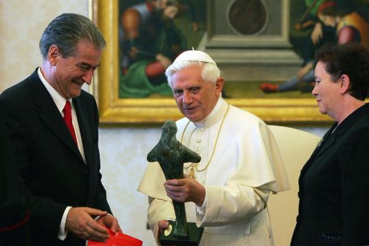 VATICAN CITY - NOVEMBER 10:  Pope Benedict XVI (C) receives a statue of Mother Teresa as a gift from Albanian Prime Minister Sali Berisha and his wife during a meeting at his private library November 10, 2005 in Vatican City. Prime Minister Beri...