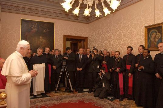 VATICAN CITY - APRIL 20:  Pope Benedict XVI (L) greets the Doctrine of the Faith group April 20, 2005 at the Vatican. Cardinal Ratzinger was elected the new Pope on April 19.  (Photo by Arturo Mari-Pool/Getty Images)