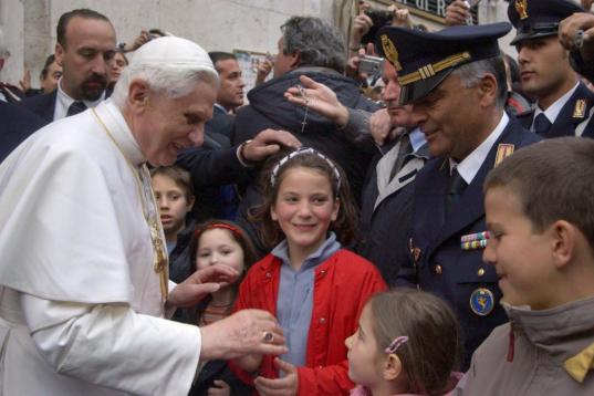 ROME, Italy:  Pope Benedict XVI is greeted by a crowd of people as he leaves his residence 20 April 2005 in Rome. Newly elected Pope Benedict XVI made his first trip outside the Vatican, to his former apartment in Rome where he was greeted by we...