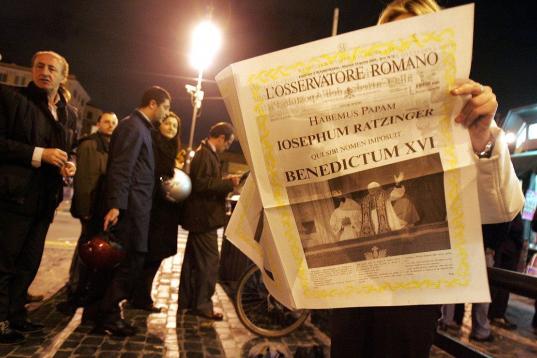 ROME - APRIL 19:  A woman reads a newly printed edition of the newspaper L'Osservatore Romano at a newstand announcing the election of Pope Benedict XVI, Cardinal Joseph Ratzinger, April 19, 2005 in Rome, Italy. The 265th Pope will lead the worl...