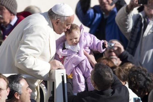 Pope Francis kisses a baby as he arrives for his weekly general audience, in St. Peter's Square, at the Vatican, Wednesday, Feb. 18, 2015. (AP Photo/Andrew Medichini)