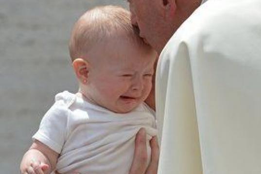 Pope Francis blesses a baby during his weekly general audience at St Peter's square on June 17, 2015 at the Vatican.  AFP PHOTO / ALBERTO PIZZOLI        (Photo credit should read ALBERTO PIZZOLI/AFP/Getty Images)