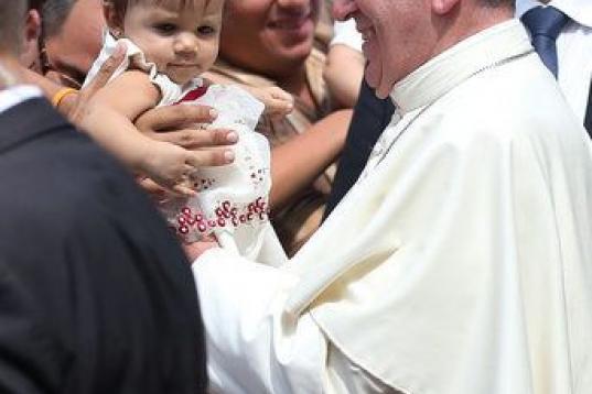 SANTIAGO DE CUBA, CUBA - SEPTEMBER 22:  Pope Francis holds a baby as he leaves the cathedral after holding a mass and blessing the city on September 22, 2015 in Santiago de Cuba, Cuba. Pope Francis leaves for the United States after spending fou...
